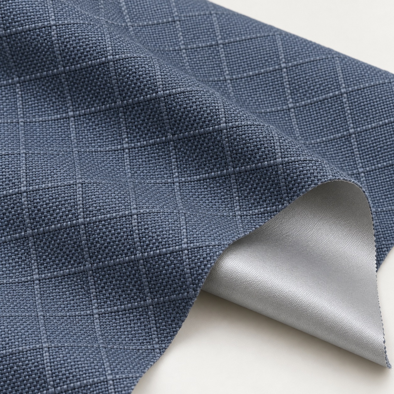 AI-generated appearance reference of blue-grey Oxford ripstop reinforcing grid and silver-coated reverse