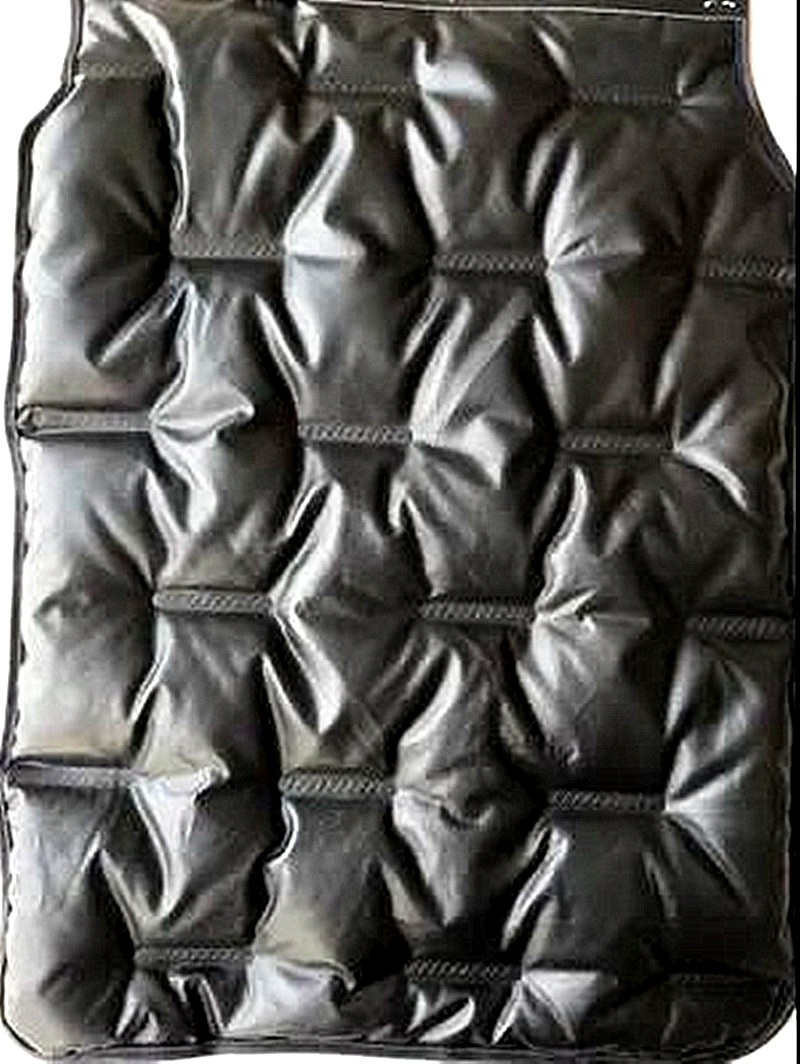 Black glossy channel-fabric sample with repeated raised sections.