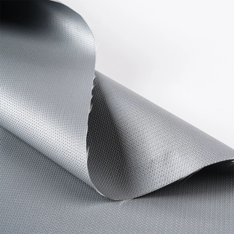 Gray coated woven fabric with a softly curled edge.