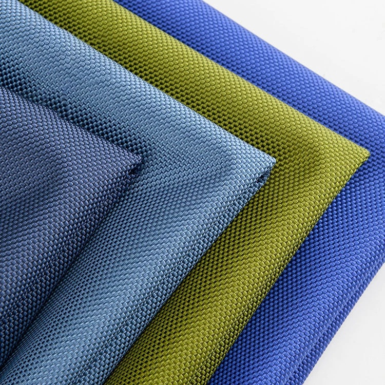 Coarse woven nylon fabric swatches in blue-gray, green and blue with folded edges.