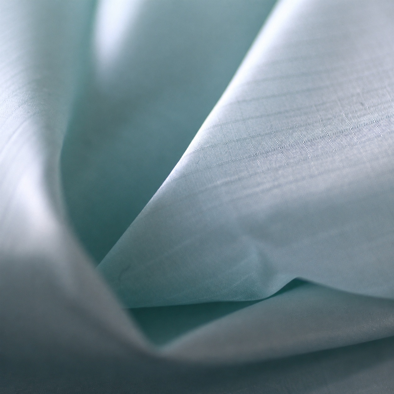 Pale blue-gray lightweight fabric with a fine grid and soft fold.