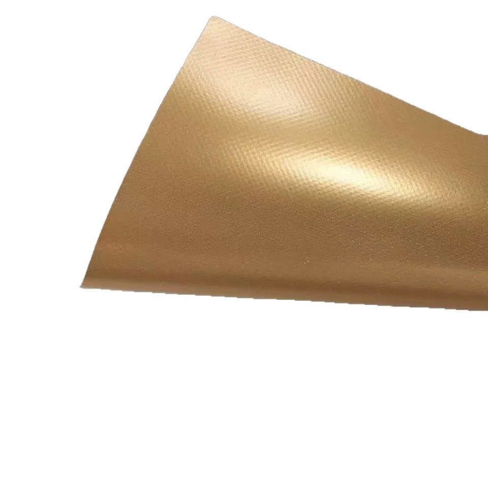 Gold-colored coated woven fabric sheet with a softly curled edge.