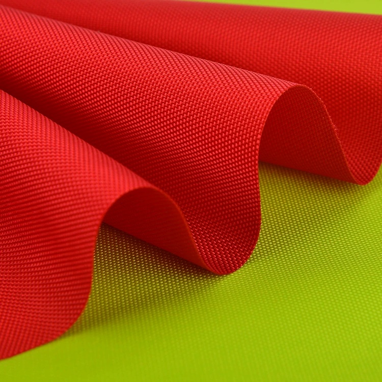 Red woven fabric in rolled folds over lime-green fabric.