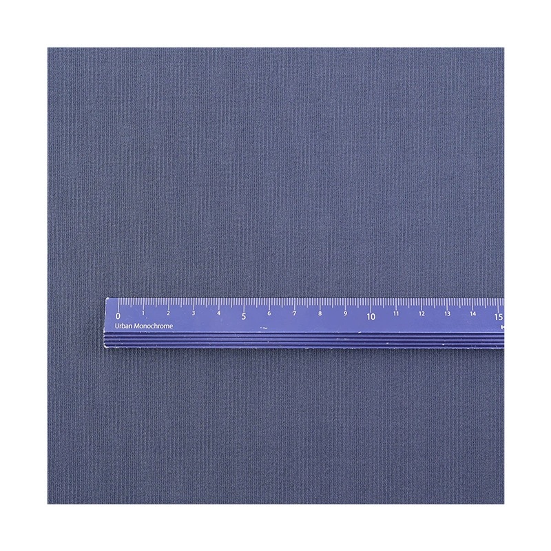 Gray-blue striped fabric with a purple ruler laid across the surface.