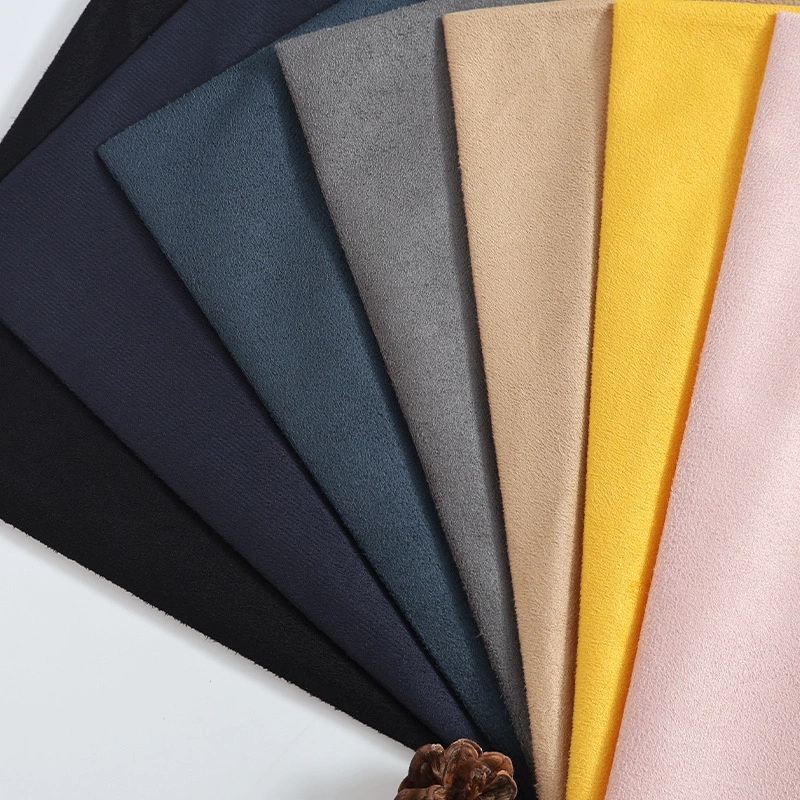 Fan of soft-textured fabric swatches in dark blue, gray, tan, yellow and pink.
