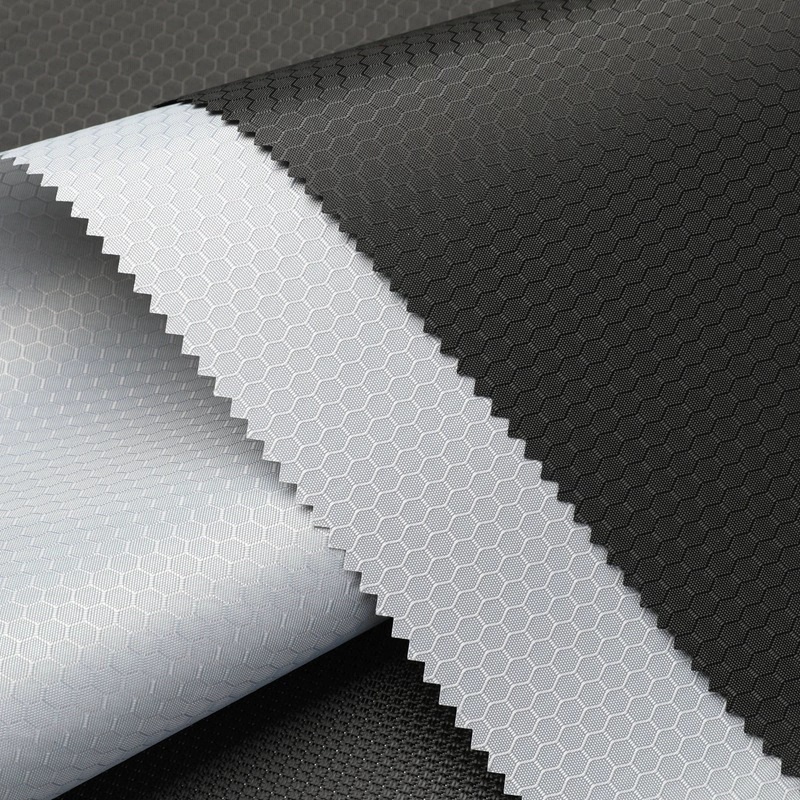 Black, gray and white fabric swatches with a visible honeycomb pattern and zigzag-cut edges.
