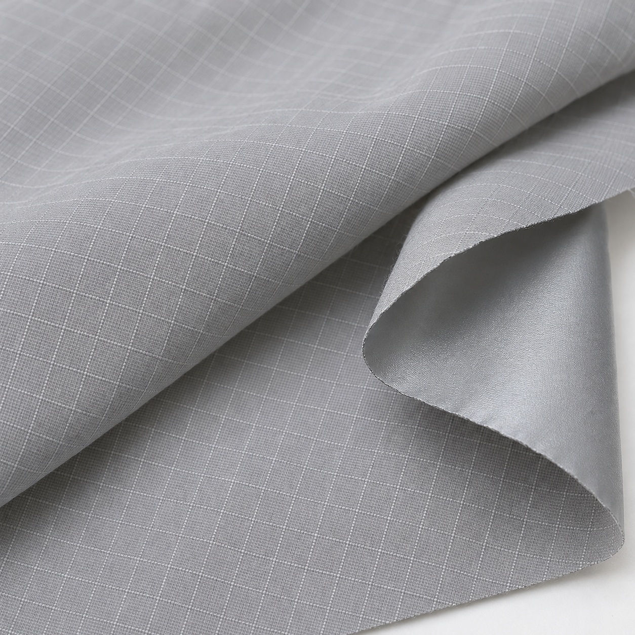 AI-generated appearance reference of light-grey polyester taffeta ripstop reinforcing grid and silver-coated reverse